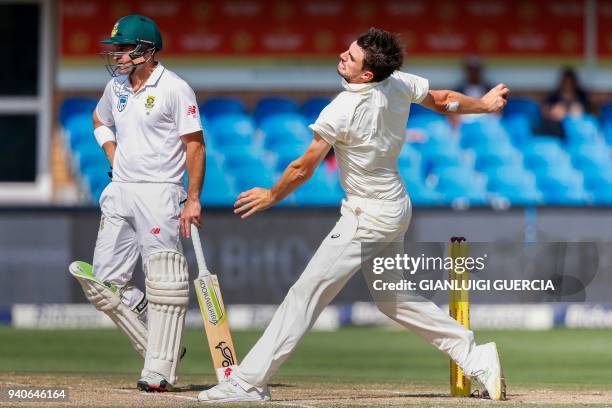 Australian cricketer Pat Cummins delivers a ball to South African batsman Aiden Markram on the third day of the fourth Test cricket match between...