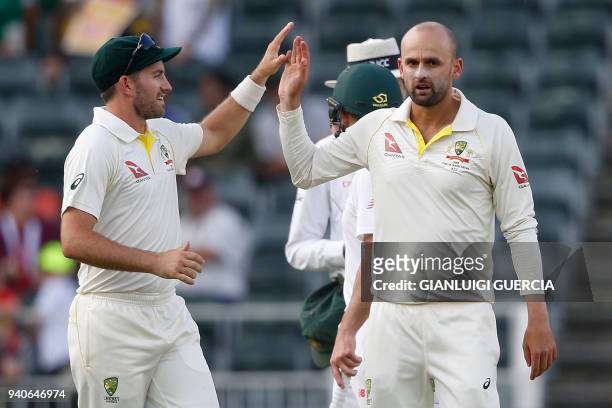 Australian bowler Nathan Lyon celebrates the dismissal of South African batsman Hashim Amla on the third day of the fourth Test cricket match between...