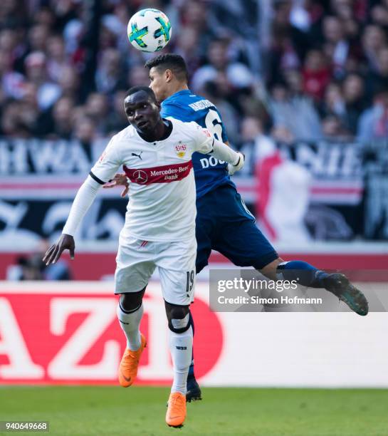 Chadrac Akolo of Stuttgart jumps for a header with Douglas Santos of Hamburg during the Bundesliga match between VfB Stuttgart and Hamburger SV at...