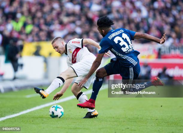 Santiago Ascacibar of Stuttgart is challenged by Mohamed Gouaida of Hamburg during the Bundesliga match between VfB Stuttgart and Hamburger SV at...