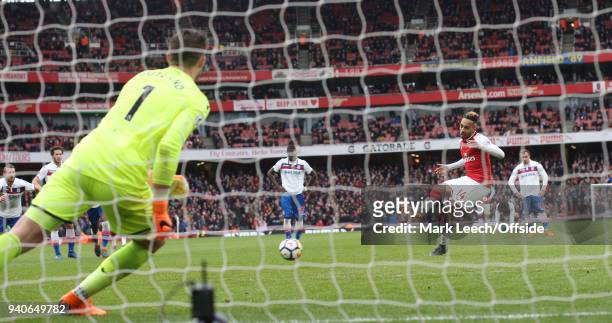 Pierre-Emerick Aubameyang of Arsenal sends Stoke goalkeeper the wrong way as he scores the opening goal from the penalty spot during the Premier...