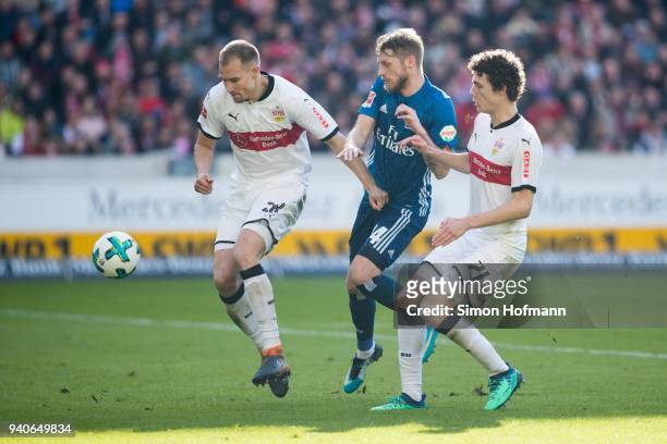 Aaron Hunt of Hamburg is challenged by Holger Badstuber of Stuttgart and Benjamin Pavard of Stuttgart during the Bundesliga match between VfB...