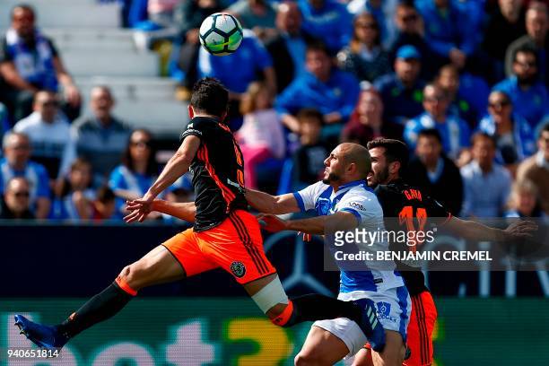 Leganes' Moroccan forward Nordin Amrabat challenges Valencia's Brazilian defender Gabriel Paulista and Valencia's Spanish defender Jose Luis Gaya...