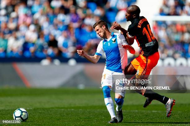 Leganes' Spanish midfielder Ruben Perez challenges Valencia's French midfielder Geoffrey Kondogbia during the Spanish League football match between...