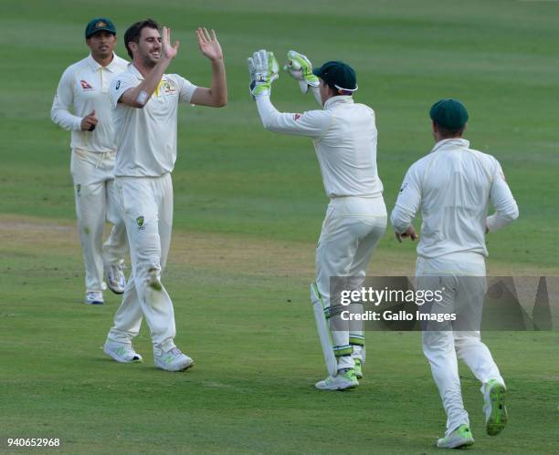 Pat Cummins of Australia celebrates the wicket of AB de Villiers of the Proteas with Tim Paine of Australia during day 3 of the 4th Sunfoil Test...