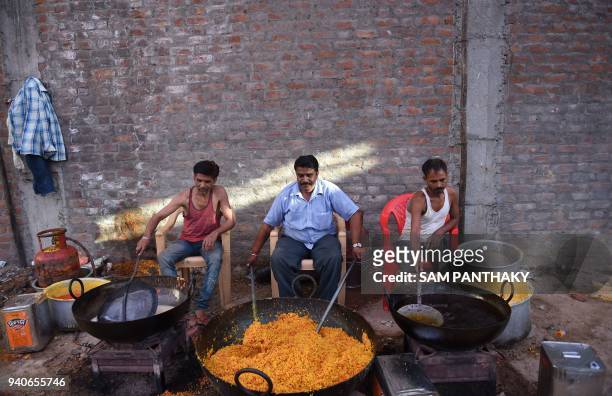 Indian skilled Laddoo makers prepare laddoos in Ahmedabad on April 1, 2018. Some 1500 Kg of laddoos are being prepared to be offered to the devotees...