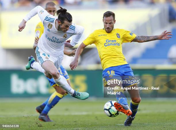 Gareth Bale of Real Madrid competes for the ball with Javi Castellano of UD Las Palmas during the La Liga match between UD Las Palmas and Real Madrid...