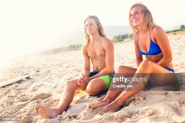 young couple on a sandy beach - slovenia beach stock pictures, royalty-free photos & images