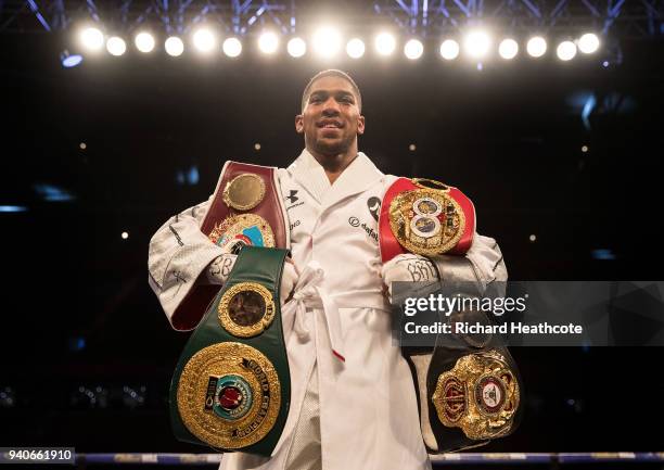 Anthony Joshua poses with his belts after his WBA, IBF, WBO & IBO Heavyweight Championship title fight at Joseph Parker Principality Stadium on March...