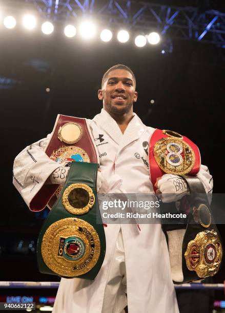 Anthony Joshua poses with his belts after his WBA, IBF, WBO & IBO Heavyweight Championship title fight at Joseph Parker Principality Stadium on March...