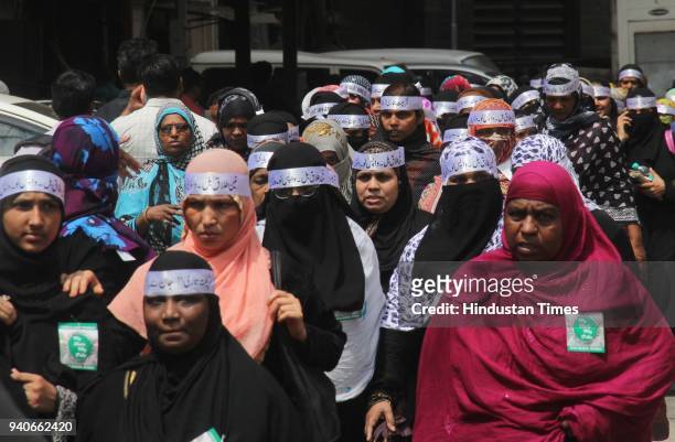 Thousands of Muslim women staged a silent protest march demanding withdrawal of the Bill banning triple talaq passed by Lok Sabha last December, at...