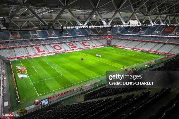 Players of Lille and Amiens compete behind closed doors on April 1, 2018 during their French L1 football match at the grand Stade Pierre-Mauroy in...