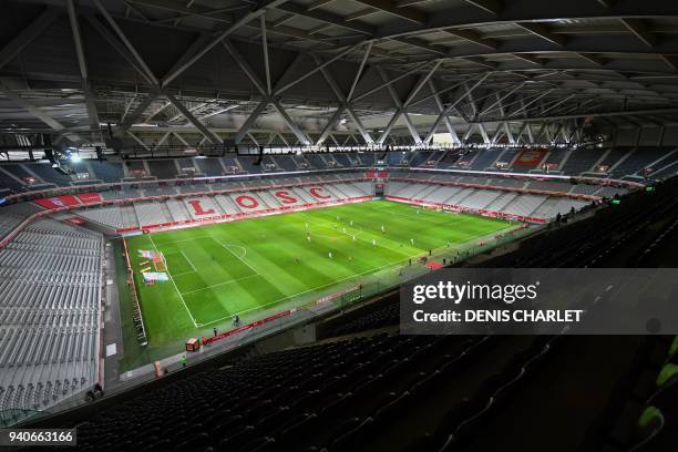 Players of Lille and Amiens compete behind closed doors on April 1, 2018 during their French L1 football match at the grand Stade Pierre-Mauroy in...