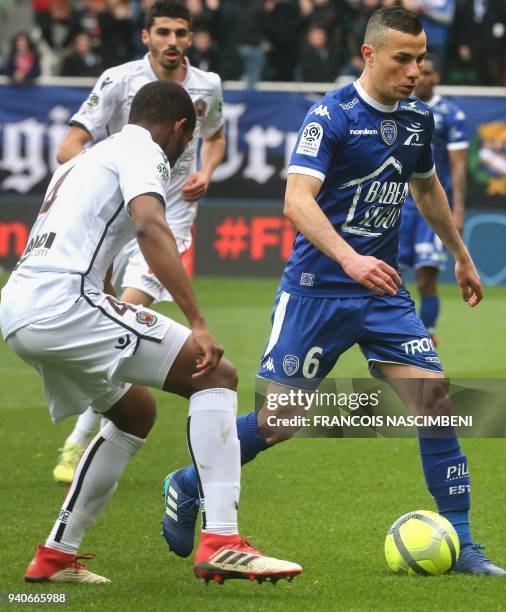Troyes' French-Algerian midfielder Karim Azamoum vies with Nice's Brazilian defender Marlon Santos during the French L1 football match between Troyes...