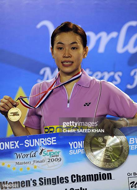 Wong Mew Choo of Malaysia poses for pictures after defeating Juliane Schenk of Germany in the Women's singles at the Badminton World Super Series...