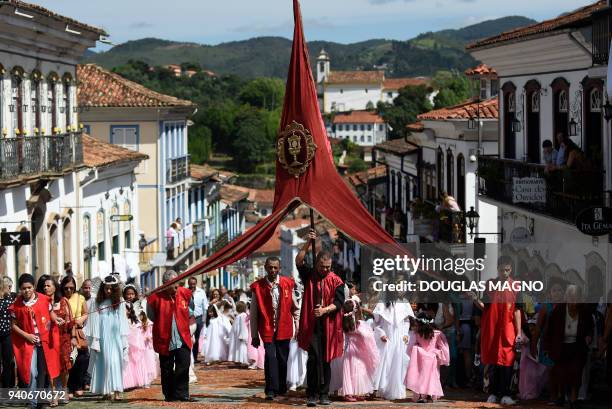 Catholics participate in an Easter Sunday procession representing the resurrection of Christ, through the streets of the Brazilian historic city of...