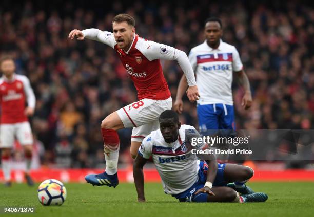 Aaron Ramsey of Arsenal knocks the ball past Badou Ndiaye of Stoke during the Premier League match between Arsenal and Stoke City at Emirates Stadium...