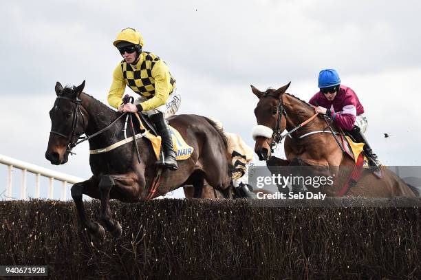 Meath , Ireland - 1 April 2018; Al Boum Photo, left, with David Mullins up, jumps the third alongside eventual second place Shattered Love, right,...