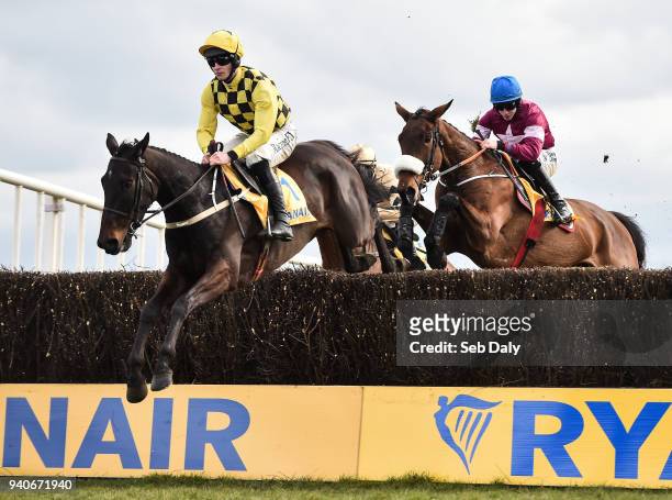 Meath , Ireland - 1 April 2018; Al Boum Photo, left, with David Mullins up, jumps the third alongside eventual second place Shattered Love, right,...
