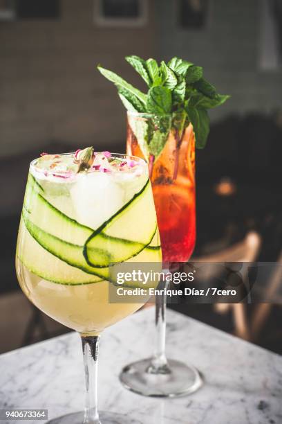 two cocktails on marble benchtop in bar, close up - cucumber cocktail stock pictures, royalty-free photos & images