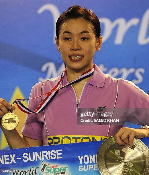 Wong Mew Choo of Malaysia poses for pictures after defeating Juliane Schenk of Germany in the Women's singles at the Badminton World Super Series...