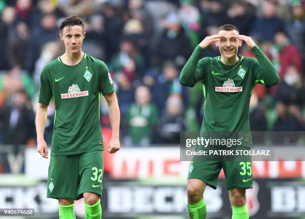 Bremen's German midfielder Maximilian Eggestein and Bremen's Austrian defender Marco Friedl react after the German first division Bundesliga football...