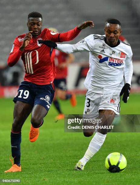 Amiens' Beninese defender Khaled Adenon outruns Lille's Ivorian forward Nicolas Pepe during the French L1 football match played behind closed doors...