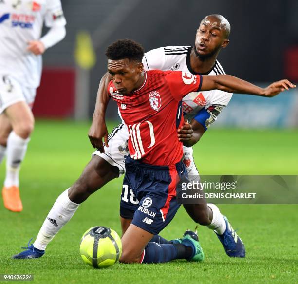 Lille's South African forward Lebo Mothiba vies with Amiens' French defender Prince-Desir Gouano during the French L1 football match played behind...