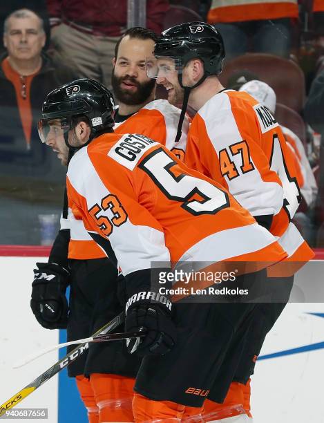Radko Gudas, Andrew MacDonald, and Shayne Gostisbehere of the Philadelphia Flyers look on during warmups prior to their game against the Boston...