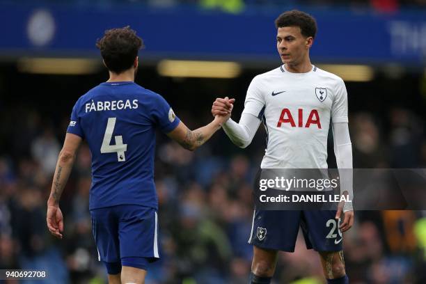 Tottenham Hotspur's English midfielder Dele Alli shakes hands with Chelsea's Spanish midfielder Cesc Fabregas during the English Premier League...