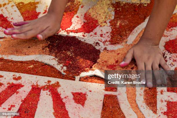 child making alfombras (sawdust carpets) - hand stencil stock pictures, royalty-free photos & images
