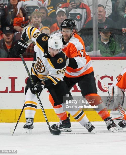 Brad Marchand of the Boston Bruins attempts a backhand scoring chance while being defended by Andrew MacDonald of the Philadelphia Flyers on April 1,...
