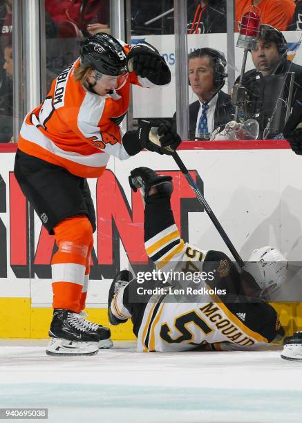 Oskar Lindblom of the Philadelphia Flyers checks Adam McQuaid of the Boston Bruins to the ice on April 1, 2018 at the Wells Fargo Center in...