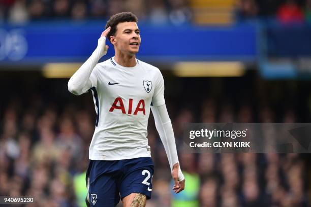 Tottenham Hotspur's English midfielder Dele Alli gestures to the Chelsea fans after scoring their second goal during the English Premier League...