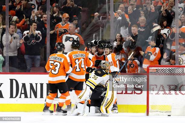 Claude Giroux of the Philadelphia Flyers celebrates with teammates after scoring a first period goal on goalie Anton Khudobin of the Boston Bruins at...