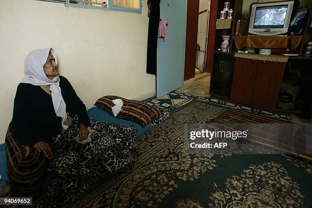 An elderly Palestinian woman watches TV at her house in the Palestinian refugee camp of Nahr al-Bared on the outskirts of the northern Lebanese...