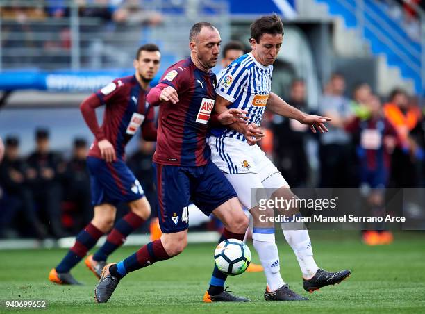 Mikel Oyarzabal of Real Sociedad duels for the ball with Ivan Ramis of SD Eibar during the La Liga match between SD Eibar and Real Sociedad de Futbol...