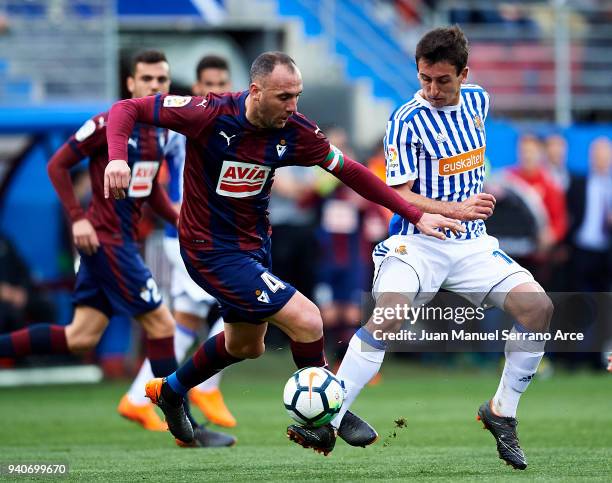 Mikel Oyarzabal of Real Sociedad duels for the ball with Ivan Ramis of SD Eibar during the La Liga match between SD Eibar and Real Sociedad de Futbol...