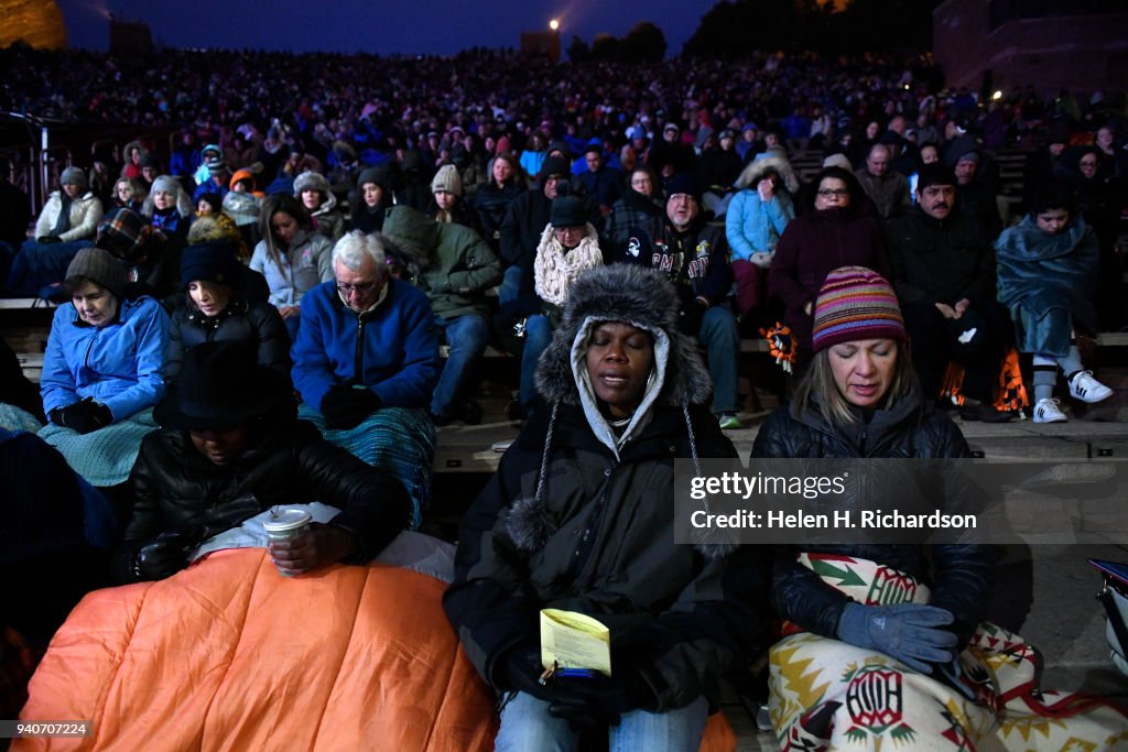 Easter sunrise service at Red Rocks under cloudy skies, cold temperatures and snow flurries.