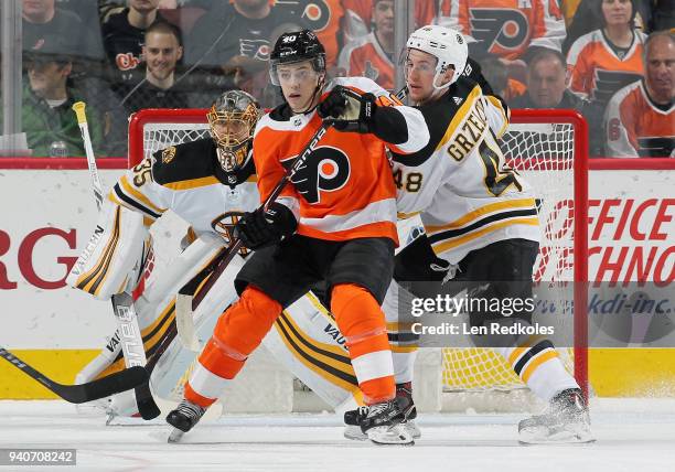 Jordan Weal of the Philadelphia Flyers battles for position in front of Anton Khudobin of the Boston Bruins with Matt Grzelcyk on April 1, 2018 at...