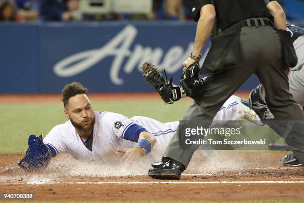 Russell Martin of the Toronto Blue Jays is tagged out at home plate by Austin Romine of the New York Yankees in the second inning during MLB game...