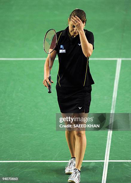 Juliane Schenk of Germany reacts after losing a point against Wong Mew Choo of Malaysia during the women's singles final at the Badminton World Super...