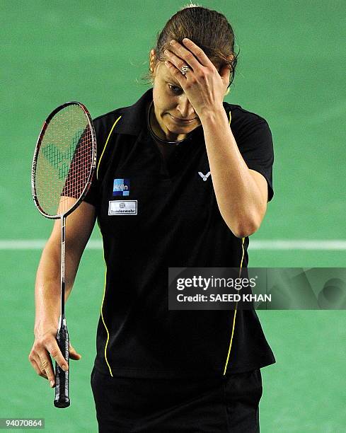 Juliane Schenk of Germany reacts after losing a point against Wong Mew Choo of Malaysia during the women's singles final at the Badminton World Super...