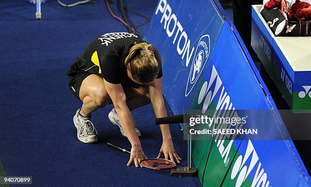 Juliane Schenk of Germany takes a moment on the sidelines after feeling unwell during her women's singles final against Wong Mew Choo of Malaysia at...
