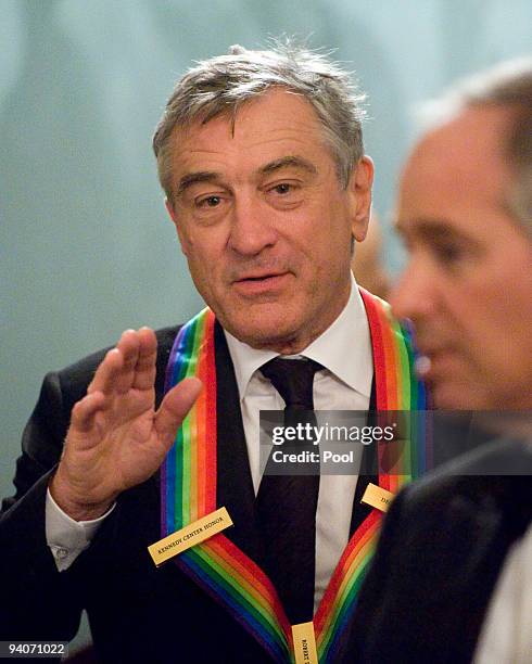 Robert De Niro gestures as he and the other 2009 Kennedy Center honorees prepare to pose for the formal group photo following the Artist's Dinner at...