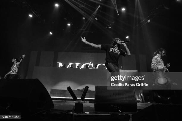 Rappers Migos perform onstage in concert during V-103 Live Pop Up Concert at Philips Arena on March 31, 2018 in Atlanta, Georgia.