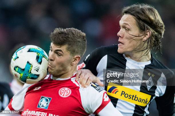 Emil Berggren of Mainz is challenged by Jannik Vestergaard of Moenchengladbach during the Bundesliga match between 1. FSV Mainz 05 and Borussia...