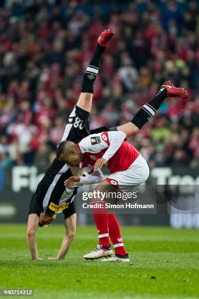 Matthias Ginter of Moenchengladbach is fouled by Robin Quaison of Mainz during the Bundesliga match between 1. FSV Mainz 05 and Borussia...