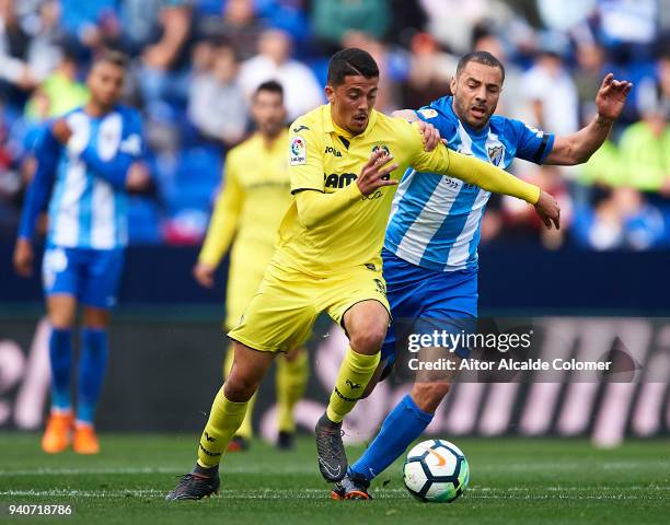 Pablo Fornals of Villarreal CF competes for the ball with Medhi Lacen of Malaga CF during the La Liga match between Malaga and Villarreal at Estadio...
