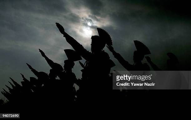 Indian Border Security Force soldiers are silhouetted against the sky as they take an oath during their passing out parade on December 06, 2009 in...